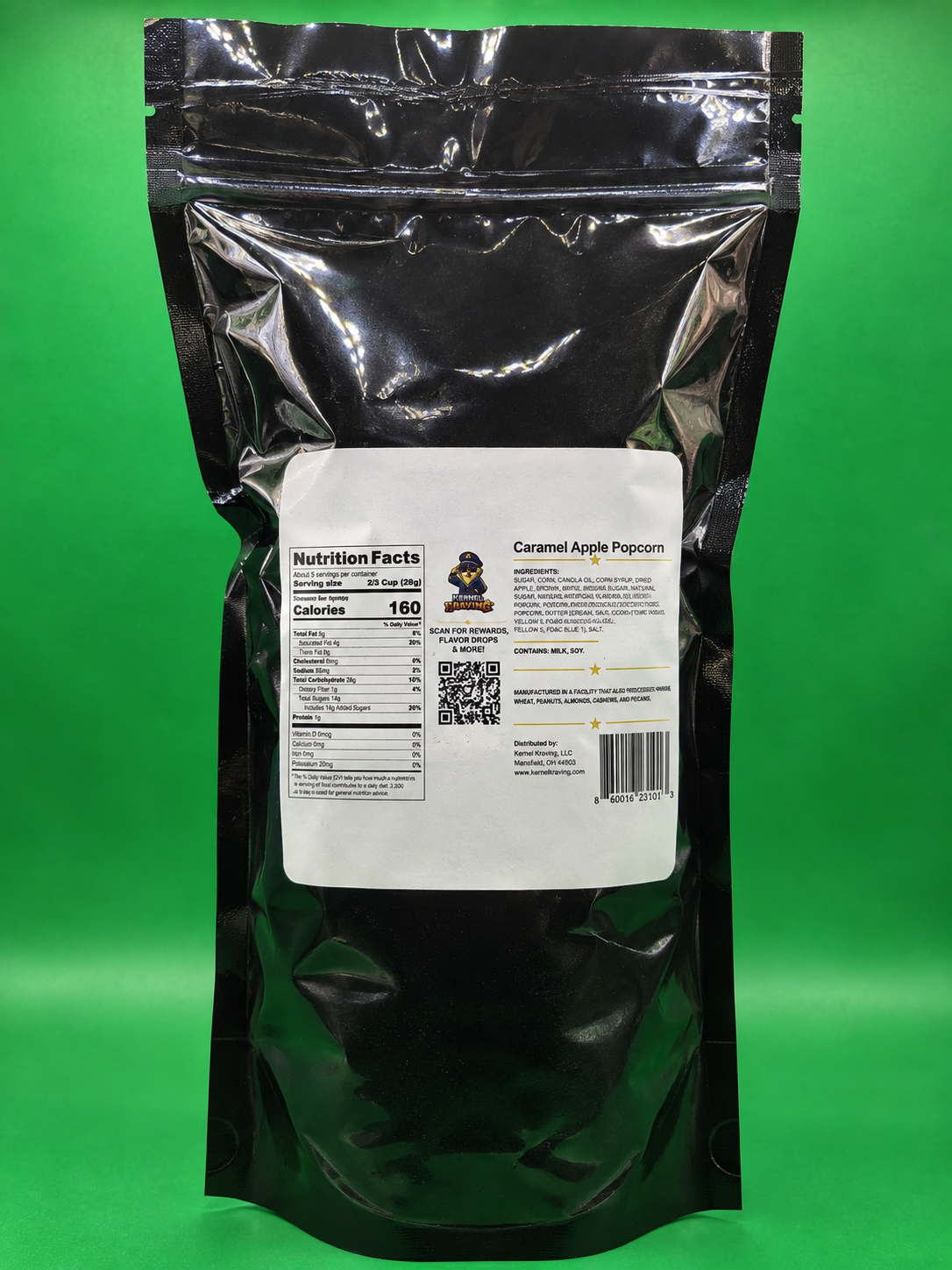 A black resealable stand-up pouch of Caramel Apple Popcorn with a white label showing nutrition facts and product details, photographed against a bright green background.